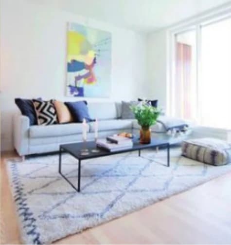 A painting by Christel Witthøft Cortz hanging above a sofa