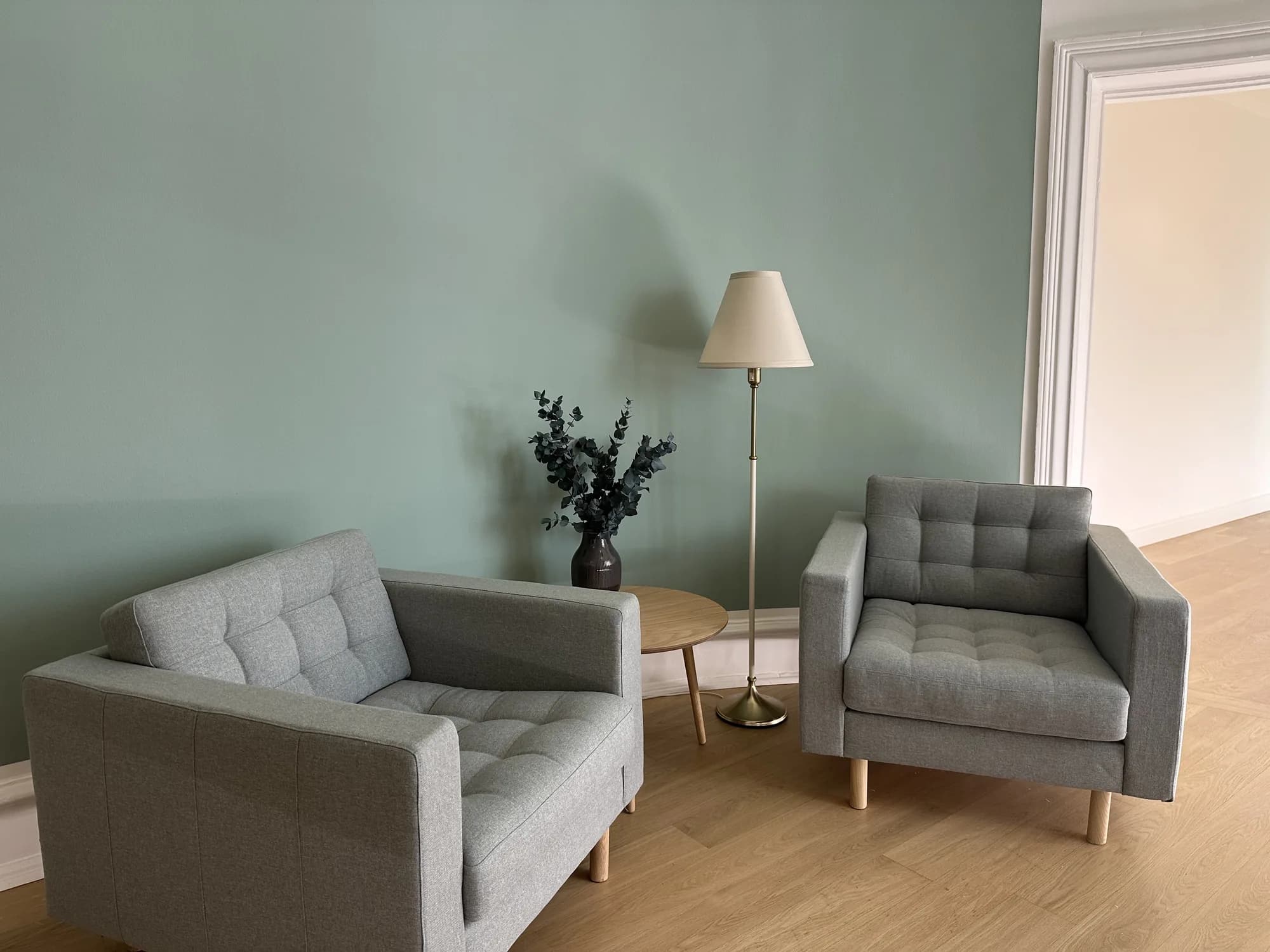 Two grey armchairs facing each other in the clinic lounge in daylight